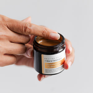 Hand holding glass jar of Marie Veronique Micronutrient + Hydro Mask 1.7oz / 50ml. Topical supplement of SUPERNUTRIENTS to hyper-hydrate, nourish + restore skin function by supporting vital processes. A total skin reset. Microbiome-friendly / Fragrance+Essential Oil free